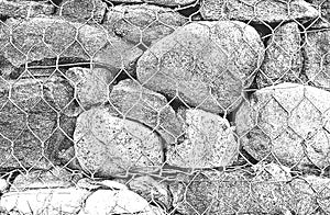 Distressed overlay texture of stones, rocks, pebbles, macadam inside the metalic mesh, net