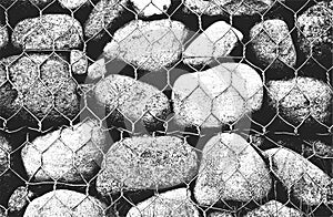 Distressed overlay texture of stones, rocks, pebbles, macadam inside the metalic mesh, net