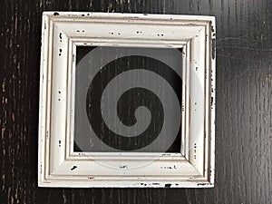 Distressed rustic wood picture frame on a black background
