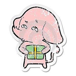 distressed sticker of a cartoon elephant with gift remembering