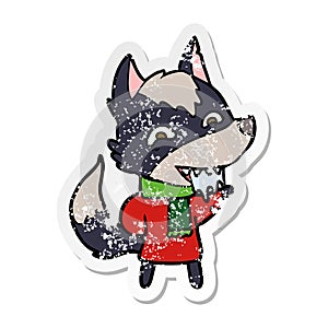 distressed sticker of a cartoon hungry wolf in winter clothes