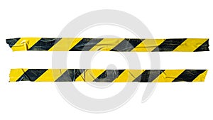 Distressed yellow and black barricade tape on white background with clipping path