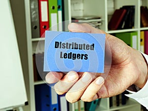 Distributed Ledgers inscription on the blue business card photo