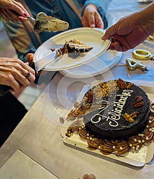 Distributing the birthday cake in a birthday celebration