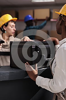 Distribution managers preparing online order for shipping in warehouse