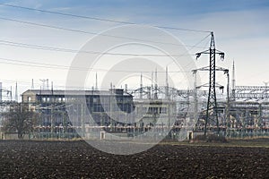 Distribution power station with electricity pylons and dramatic cloudy sky