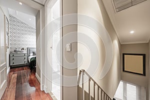 Distributor corridor of an attic loft house with stairs, reddish parquet