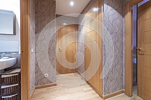 distributor of a house with oak parquet flooring with access to a toilet, fitted wardrobes and access to other rooms with oak