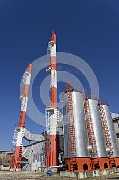 District Heating Plant Exterior With Industrial Chimneys Against the Blue Sky