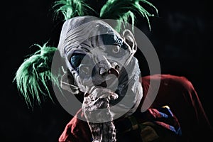 Disturbing evil clown wearing a face mask