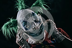 Disturbing evil clown wearing a face mask