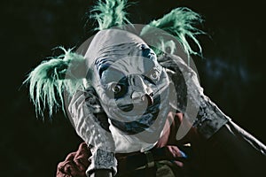 Disturbing evil clown wearing a face mask