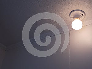 Disturbing round lightbulb on white