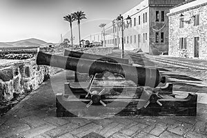 Disused cannons on the historic ramparts in Alghero, Sardinia, Italy