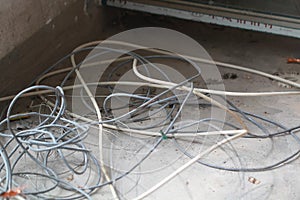 Disused discarded ruined abandoned LAN cable wires roll circle rope on the floor renovation decoration refurbish garbage trash