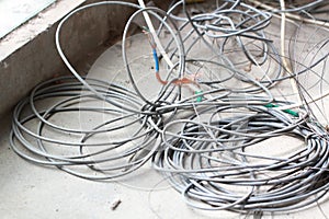 Disused discarded ruined abandoned LAN cable wires roll circle rope on the floor renovation decoration refurbish garbage trash