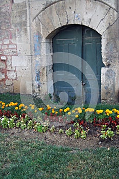 Disused old city green garden arched doorway.
