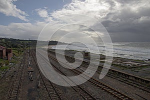 Disused Railway Tracks with Cloudy Sky and Sea