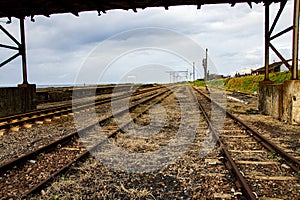 Disused Railway Tracks Passing under a Metal Bridge