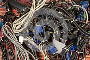Disused stack of old computer cables and devices.