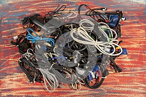 Disused stack of old computer cables and devices.