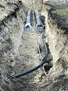 A ditch is dug and new pipe and electric lines are laid