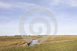 Ditch and meadows in waterland near uitdam in noord-holland