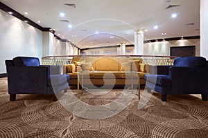 Divan and armchair inside lighting hall photo