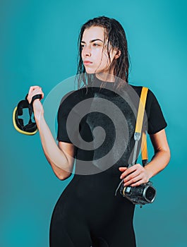 Dive deep. Sensual woman with scuba gear and dive equipment. Sexy diver with wet hair holding dive mask and camera for