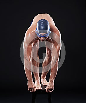 Dive right in. Full length studio shot of a young male swimmer about to dive.