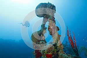 Diver Descending Toward Shipwreck Scaffolding