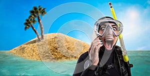 Diver in diving gear, desert island on background