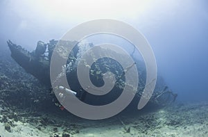 Diver exploring a large shipwreck