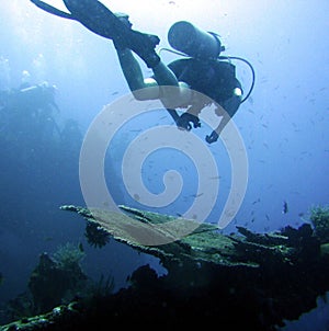 Diver exploring wrecked ship