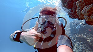 Diver looks at the camera and gives a thumbs up