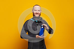 Diver man with plastic bottle on colorful orange background