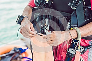 Diver prepares his equipment for diving in the sea