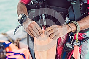 Diver prepares his equipment for diving in the sea