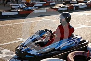 Diver racing on go-cart track outdoors enjoying competitive activity