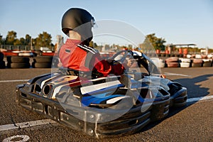 Diver racing on go-cart track outdoors enjoying competitive activity