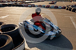 Diver racing on go-cart track outdoors enjoying competitive activity