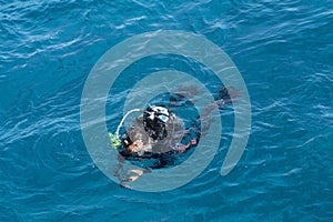 Diver with scuba swimming in Red sea, Egypt