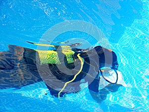 Diver swim in pool with instruction for learning