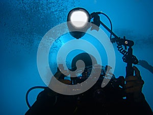 Diver with underwater camera and light