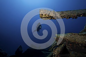 Diver underwater with ship