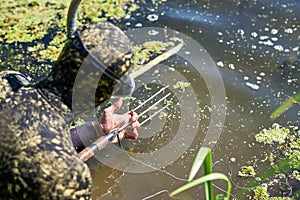 diver in wet suit loading harpoon shotgun for water hunting fishing in a river