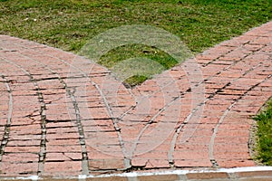 Divergent brick paths in teh grass