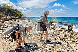 Divers on beach ready to dive in sea