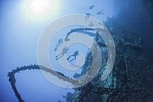 Divers on a deep underwater shipwreck
