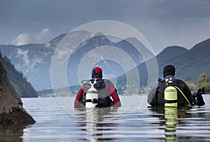 Divers entering water in mountain lake